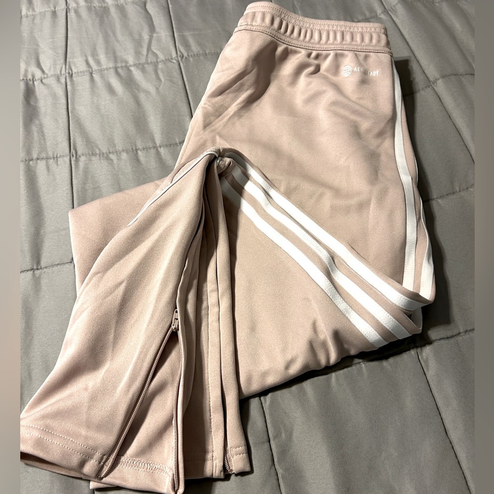 Adidas joggers size m tan color zipper pockets and bottoms of legs have zippers